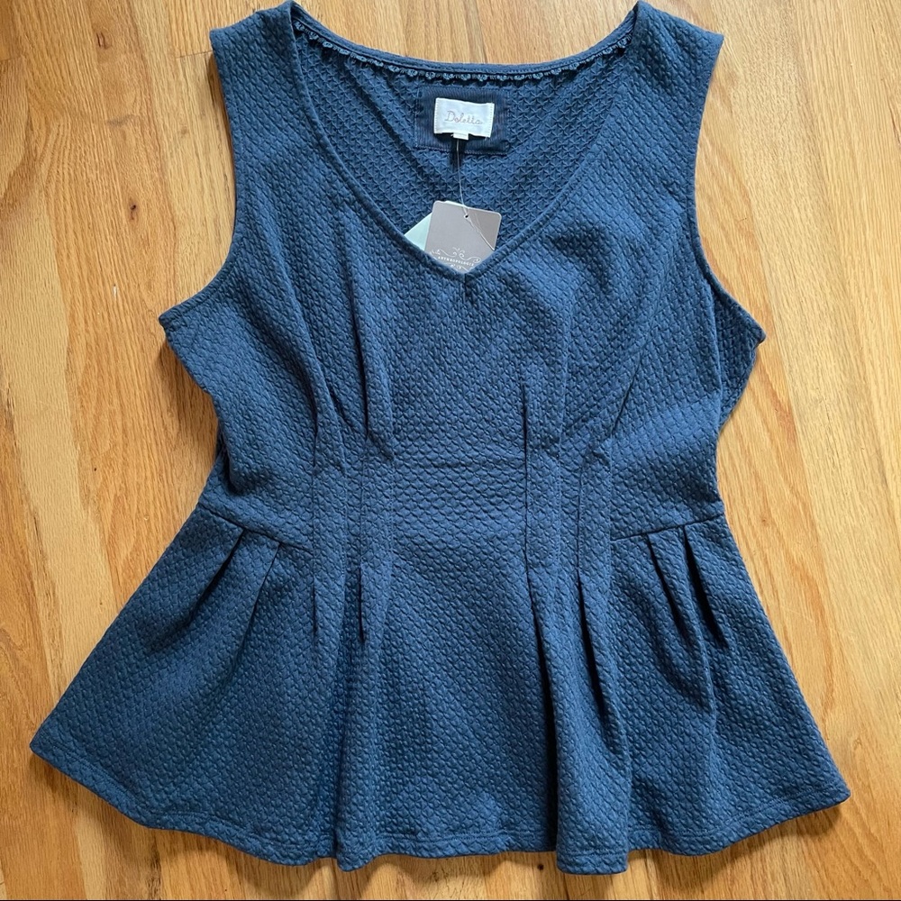 Large peplum style sleeveless top.